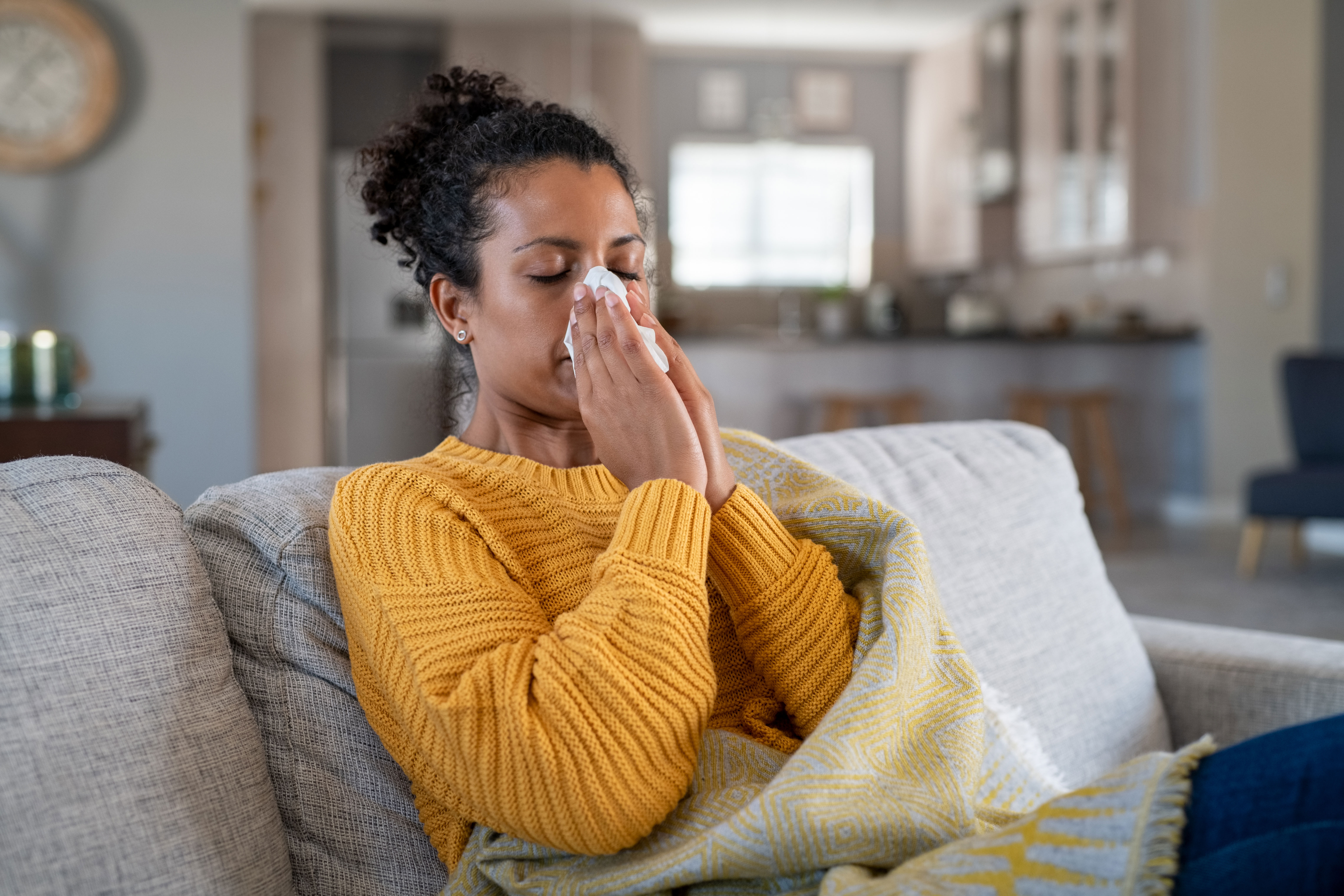 Woman blowing her nose