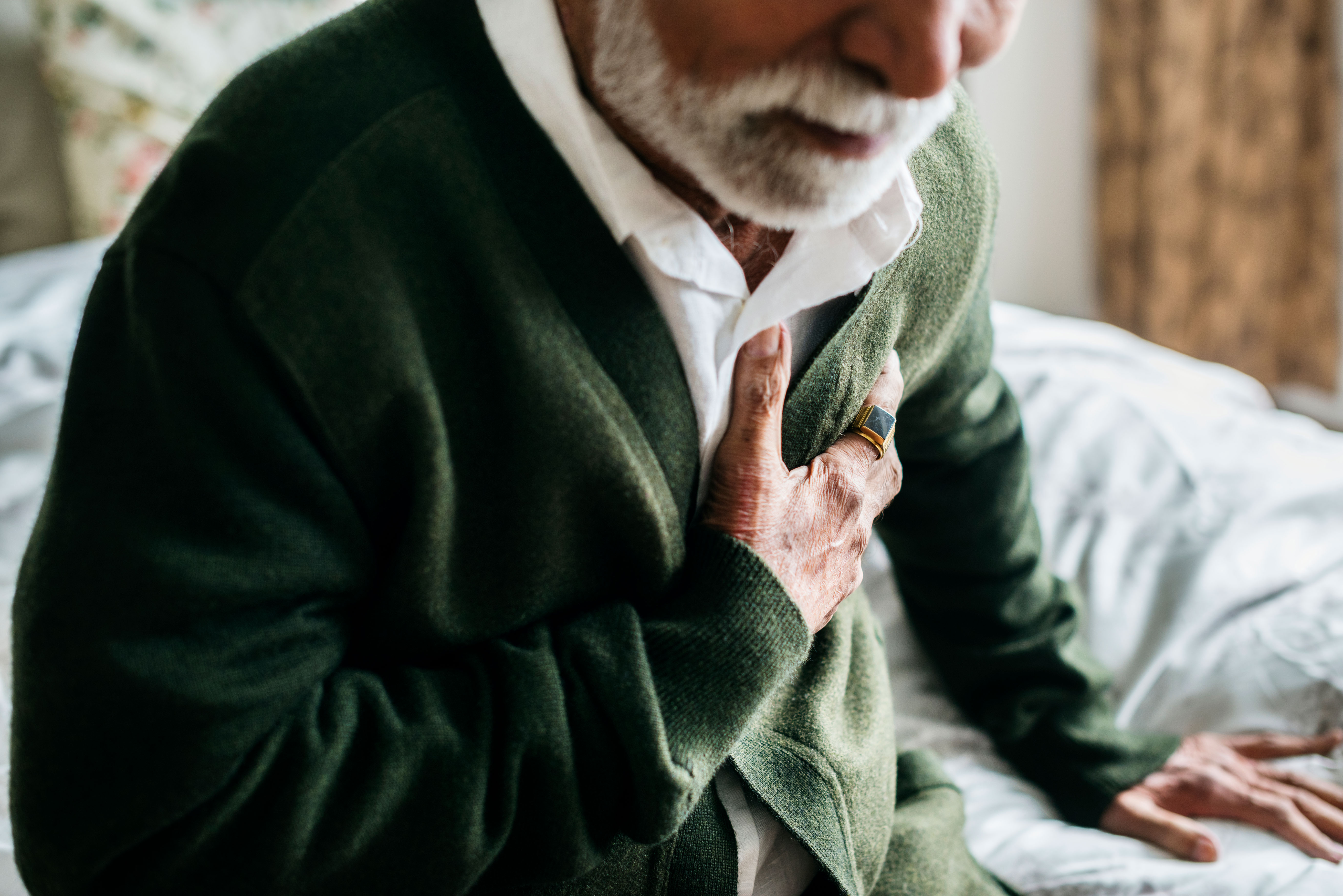 An older man experiencing heart attack symptoms