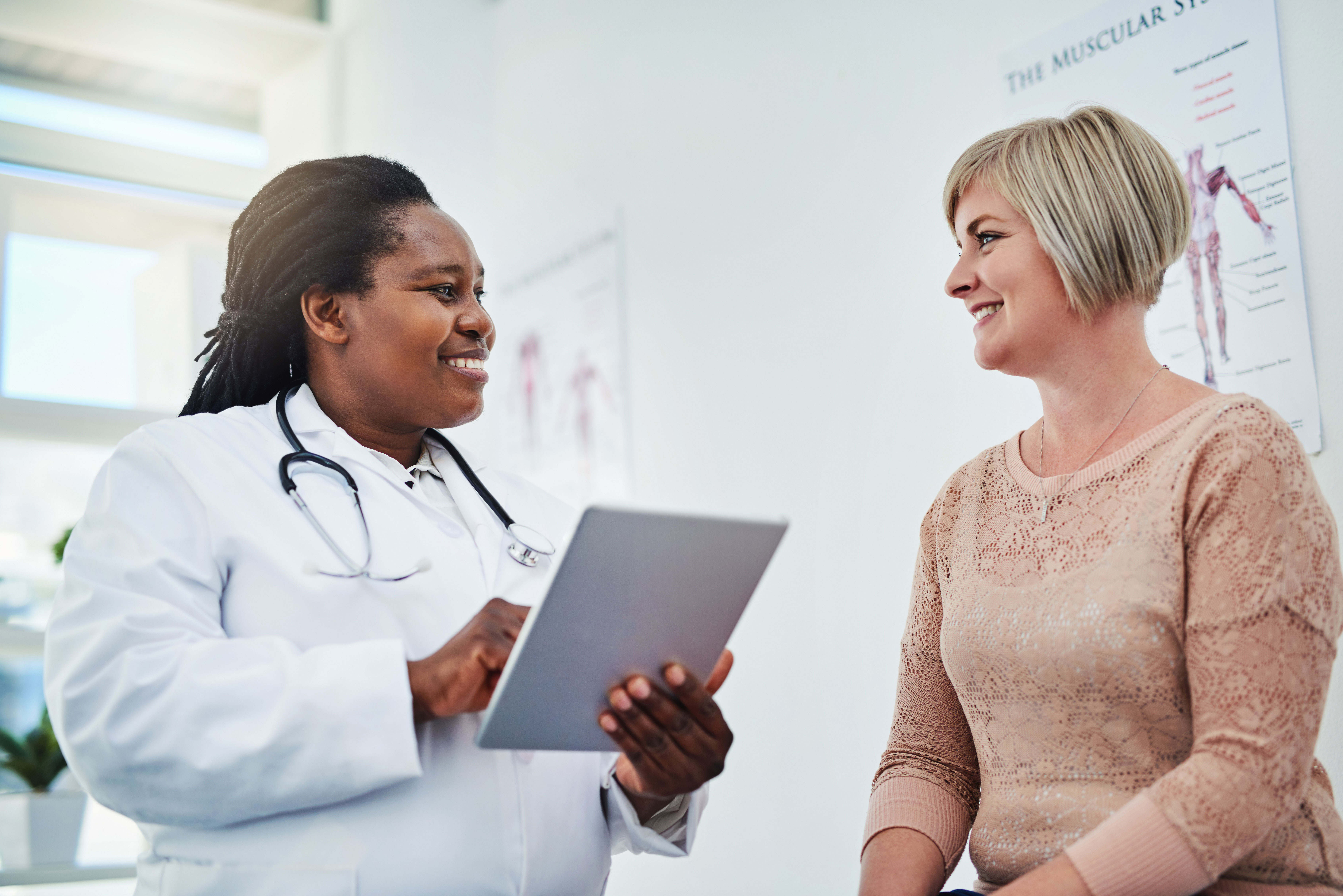Doctor discussing health screenings with a patient Doctor discussing health screenings with a patient