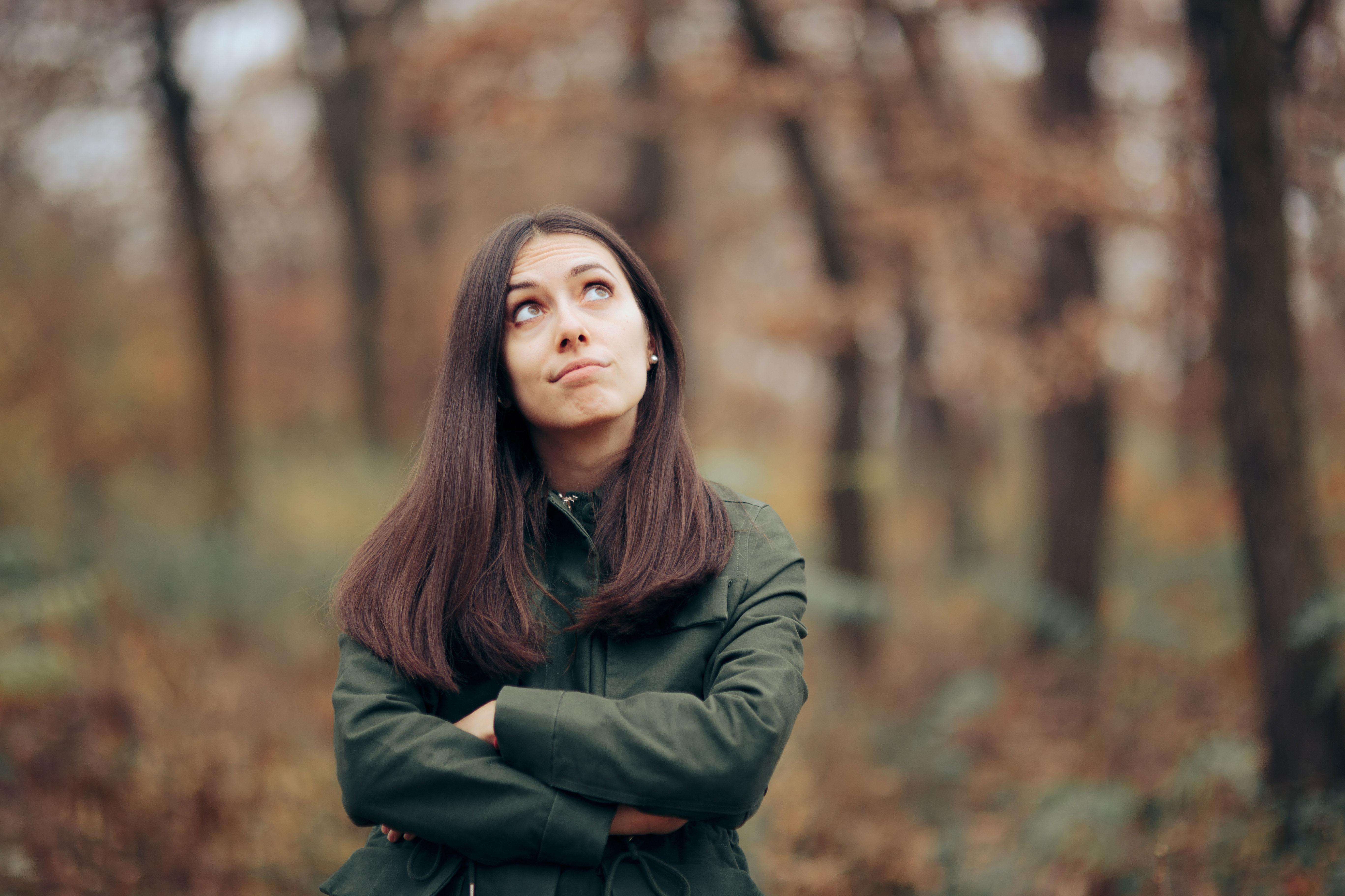 Women walking in the Fall with a gloomy expression Women walking in the Fall with a gloomy expression