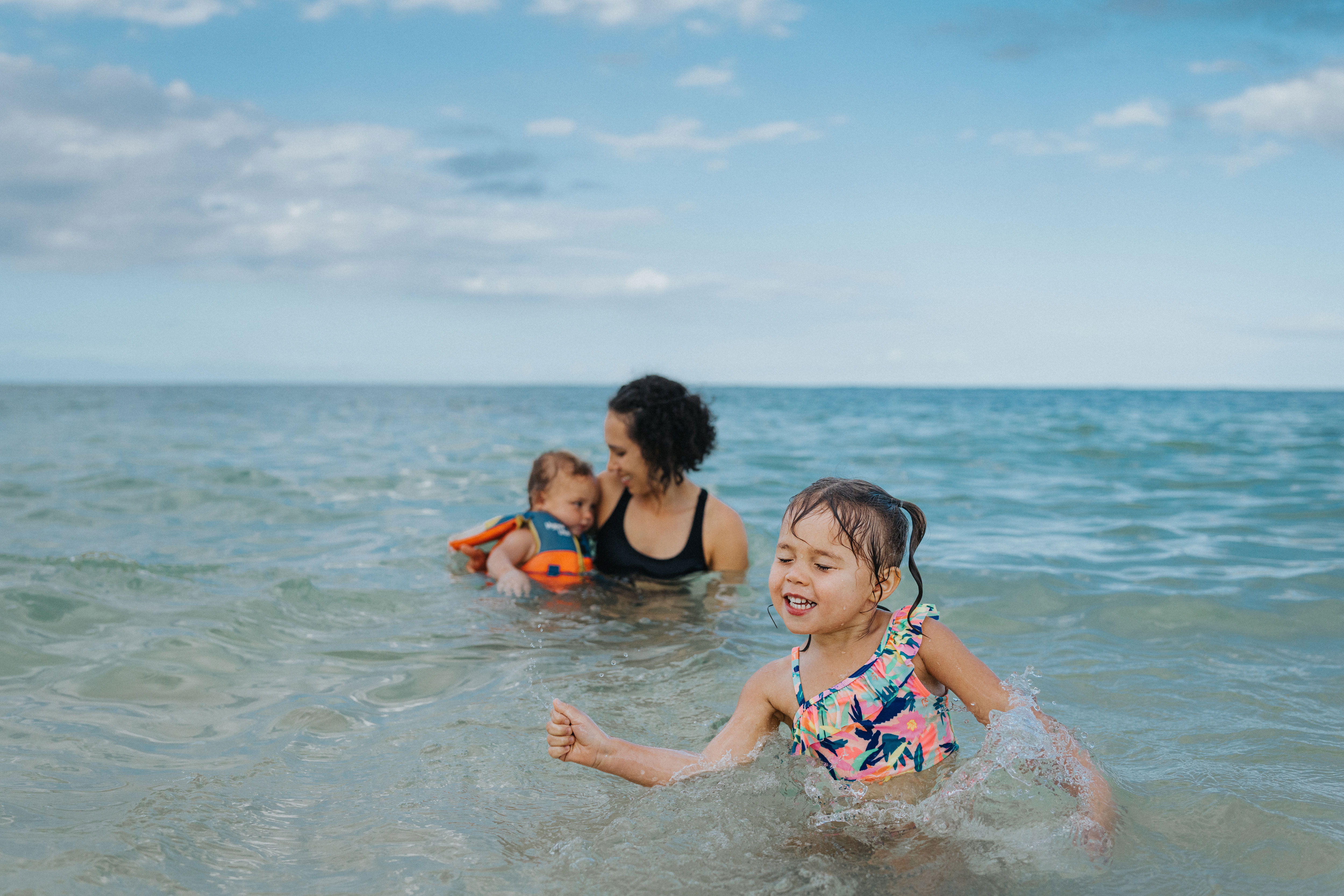 Family swimming at the beach