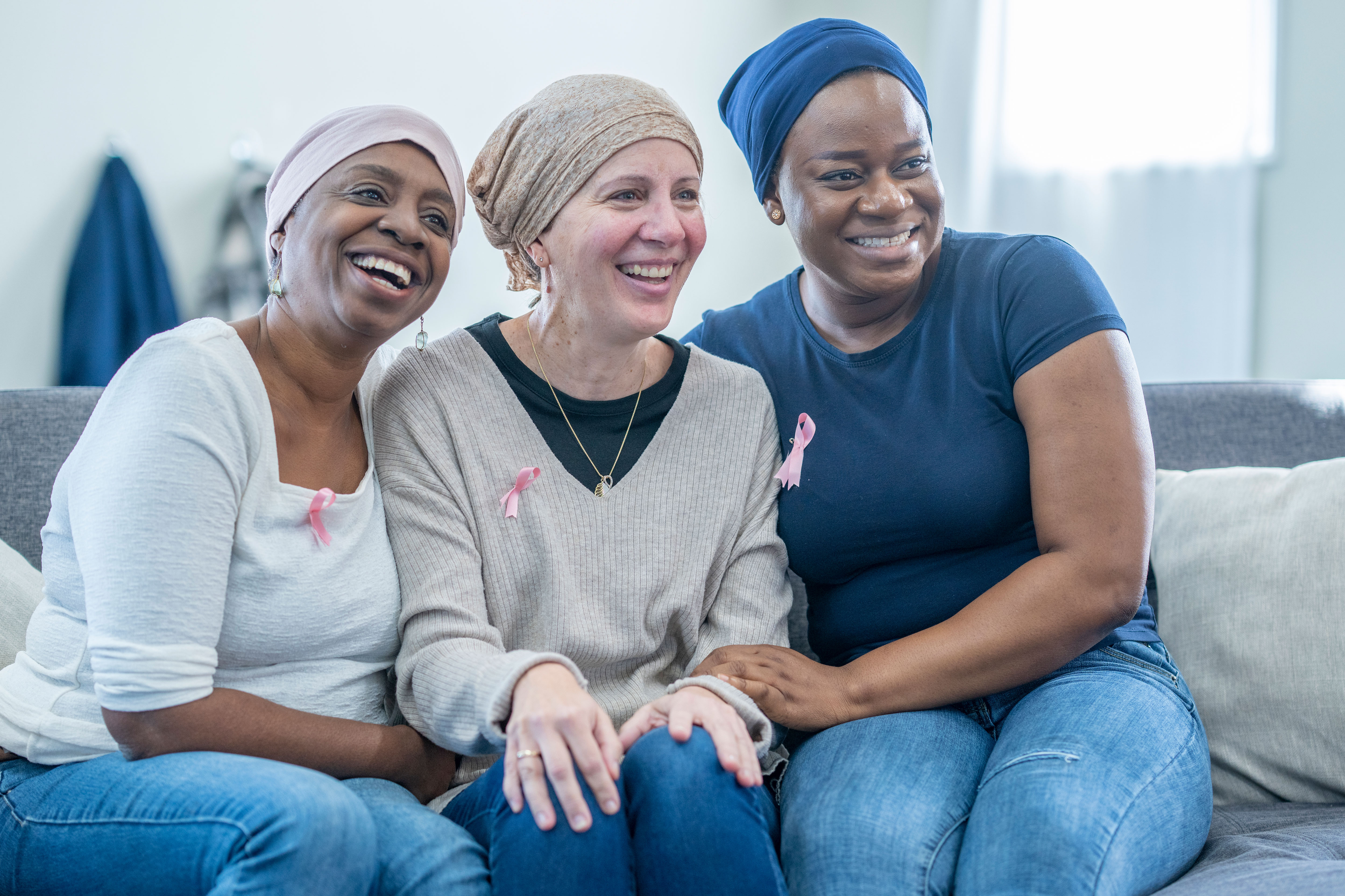 Three breast cancer survivors sit together