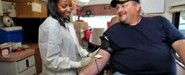 Man donating blood on bloodmobile