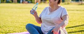 Woman on yoga mat outside