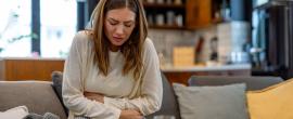 Sick woman holding her stomach