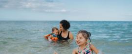 Family swimming at the beach