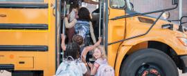 Young children get onto the school bus