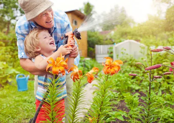 Grandparent playing in the garden with grandson
