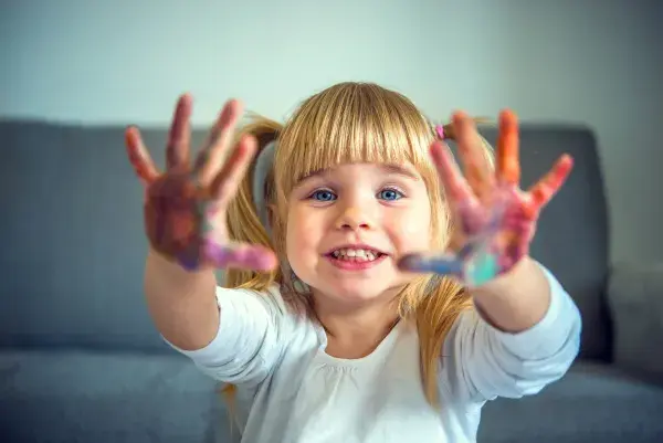 Little girl with paint on her hands