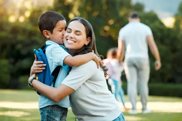 Mother hugging her son on first day of school