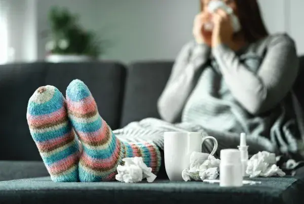 Sick woman with tissues