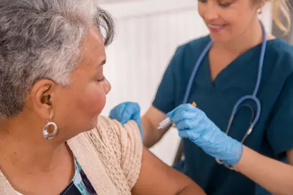 Patient gets a flu shot from a healthcare worker