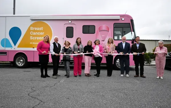 TidalHealth Mobile Mammography ribbon cutting - group of people standing in front of new unit with ribbon