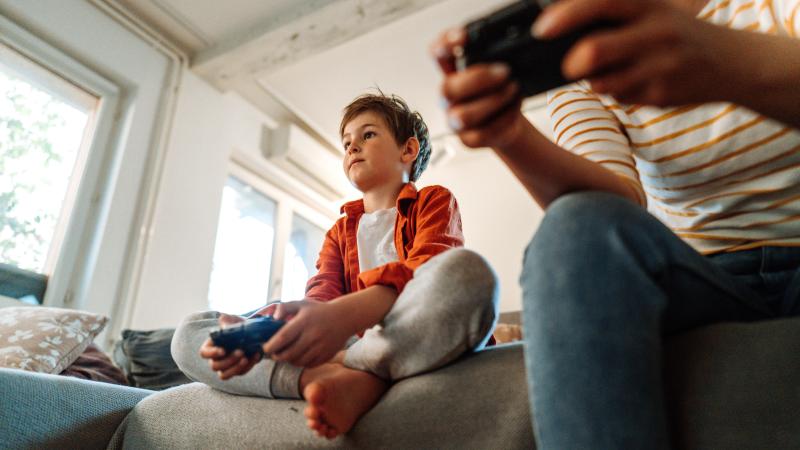 Mother and son playing a video game