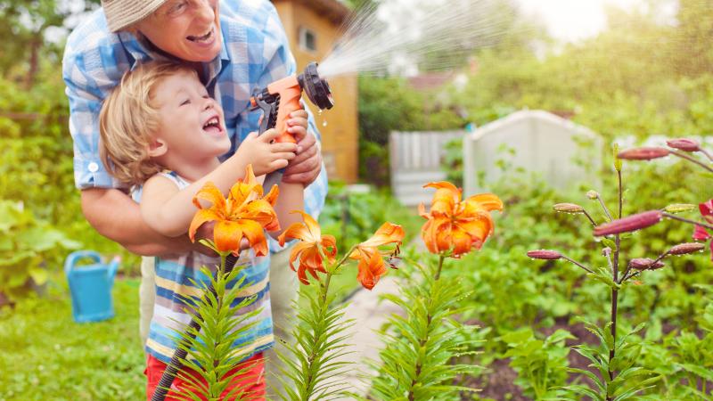 Grandparent playing in the garden with grandson