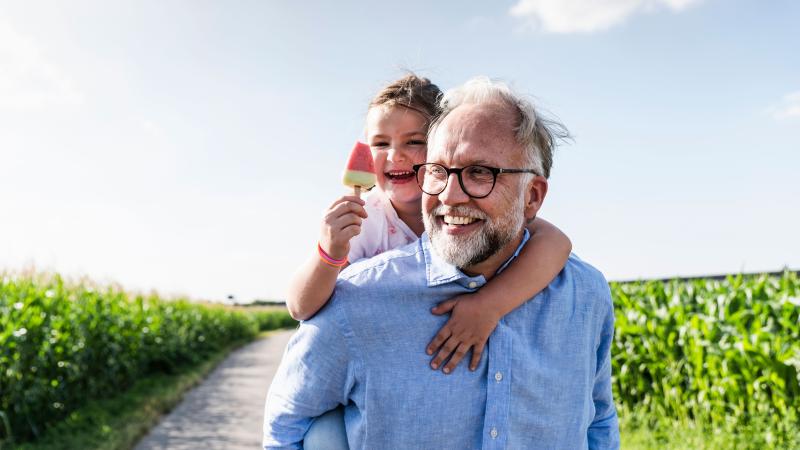 Grandfather walking with granddaughter