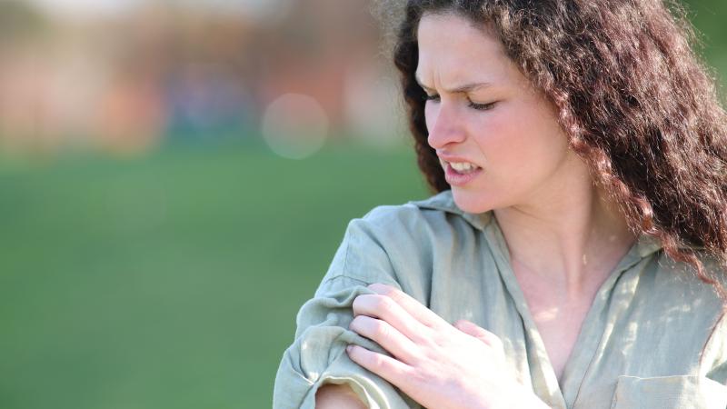 Woman itching her arm