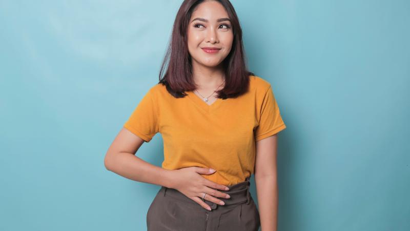 Woman with her hand on her stomach