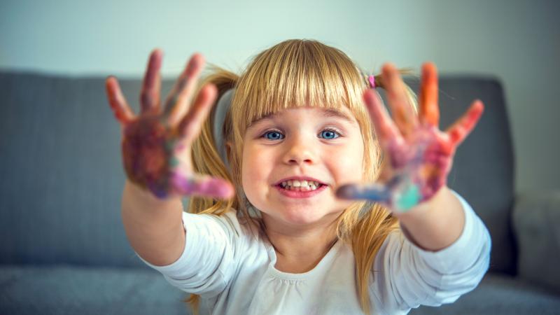 Little girl with paint on her hands