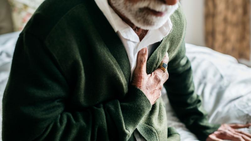 An older man experiencing heart attack symptoms