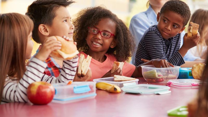 Young kids eating school lunch together