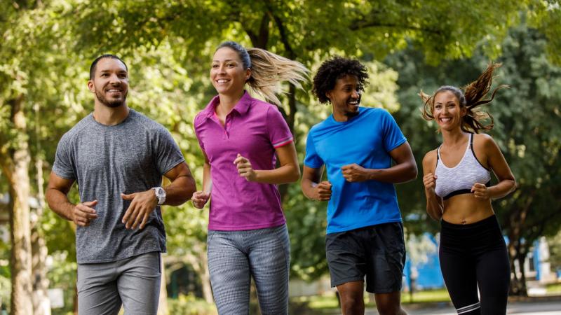 Four friends running outside