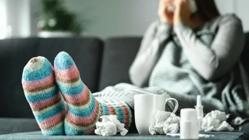 Sick woman with tissues