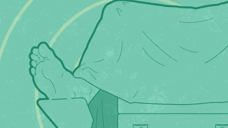 Graphic of end of woman on exam table, legs draped over and foot on stirrups