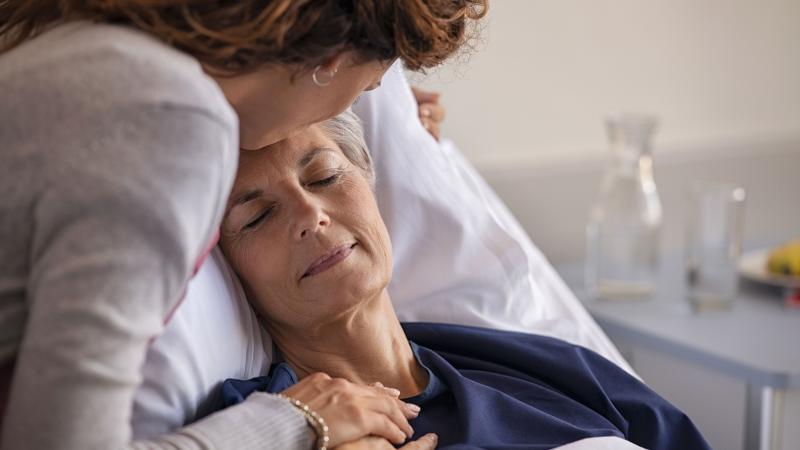 Daughter comforting mother in the hospital