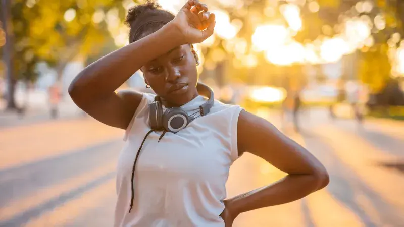 Exhausted female runner outside in the heat