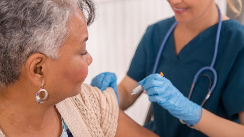 Patient gets a flu shot from a healthcare worker