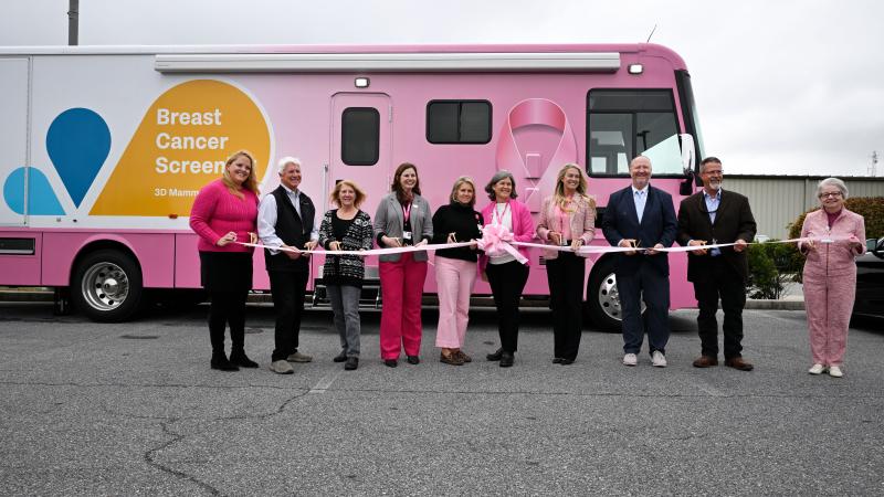 TidalHealth Mobile Mammography ribbon cutting - group of people standing in front of new unit with ribbon