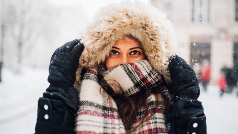 Woman bundled up in cold and snow