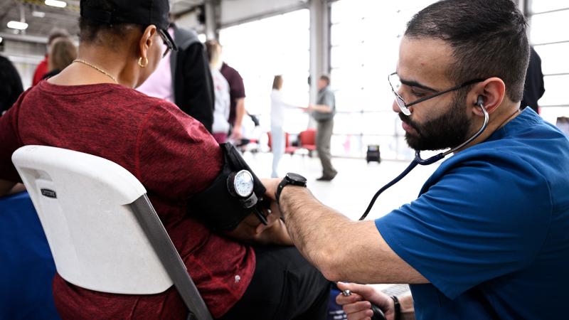 A person gets a screening at HealthFest.