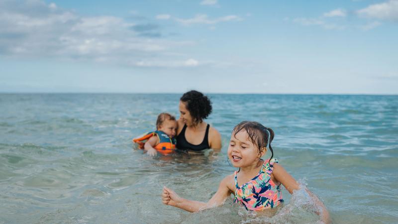Family swimming at the beach