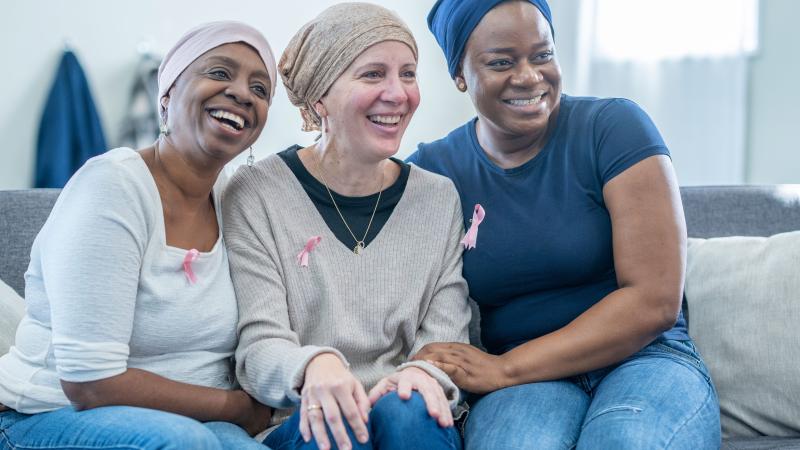 Three breast cancer survivors sit together