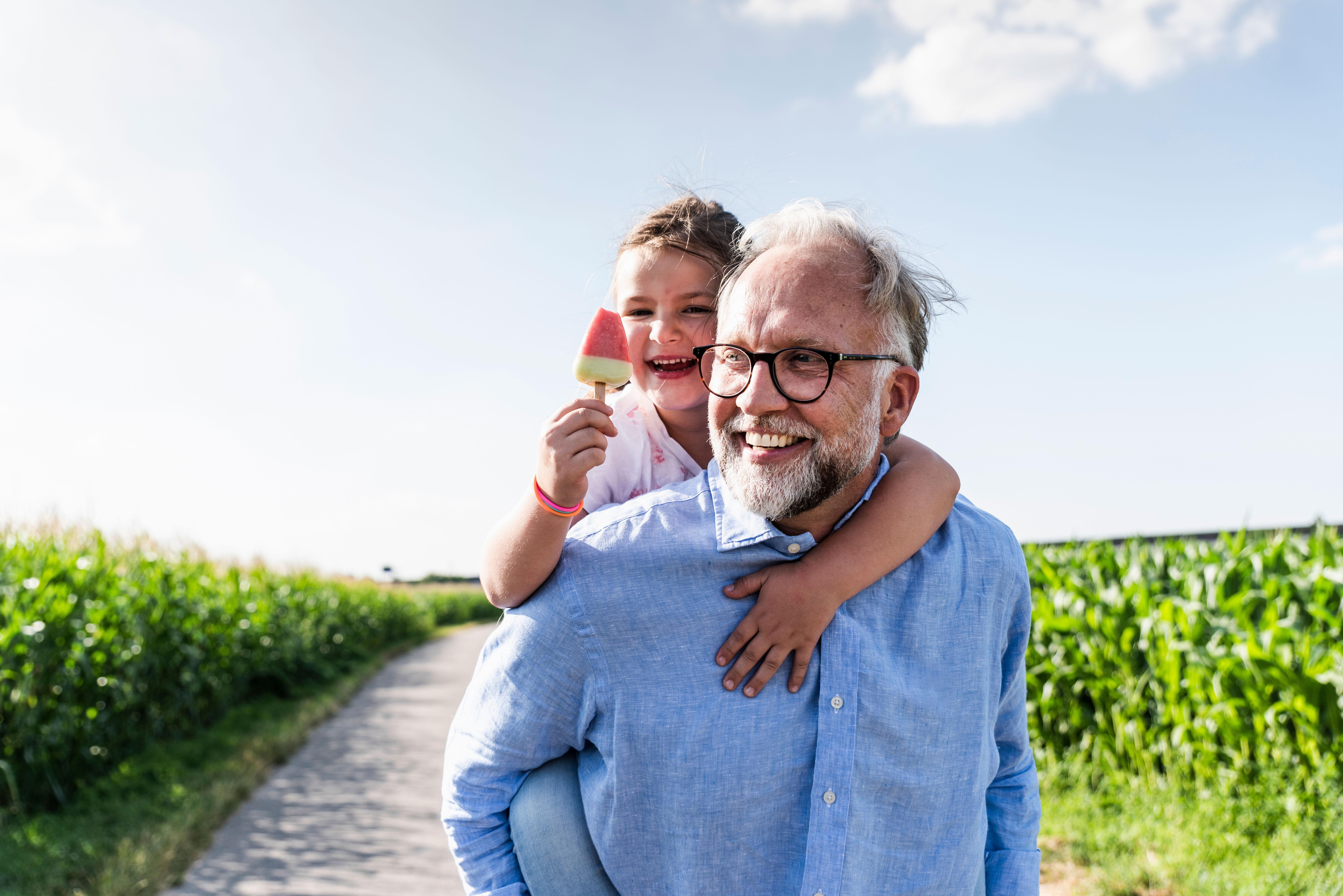 Grandfather walking with granddaughter