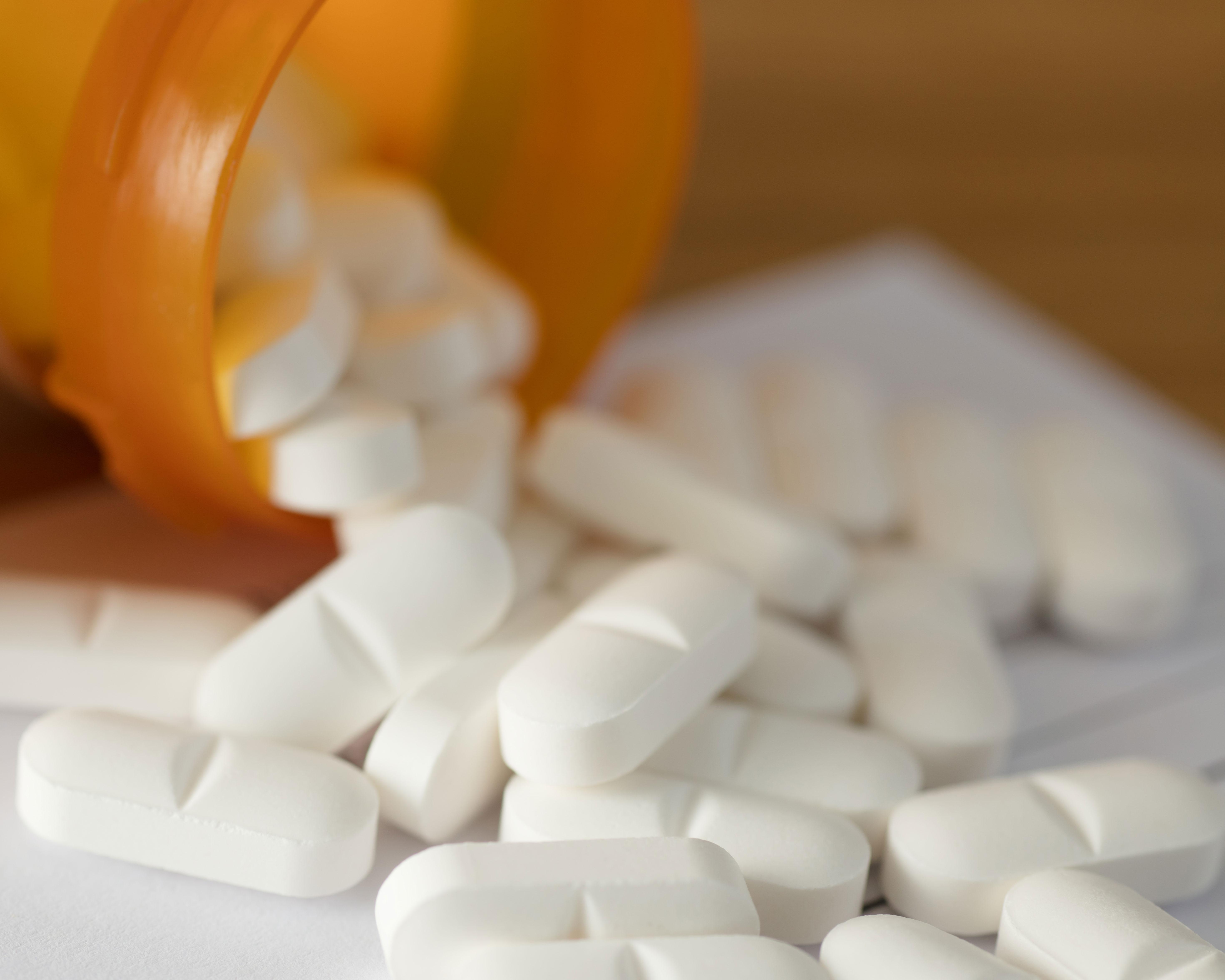 Medication bottle spilling onto table
