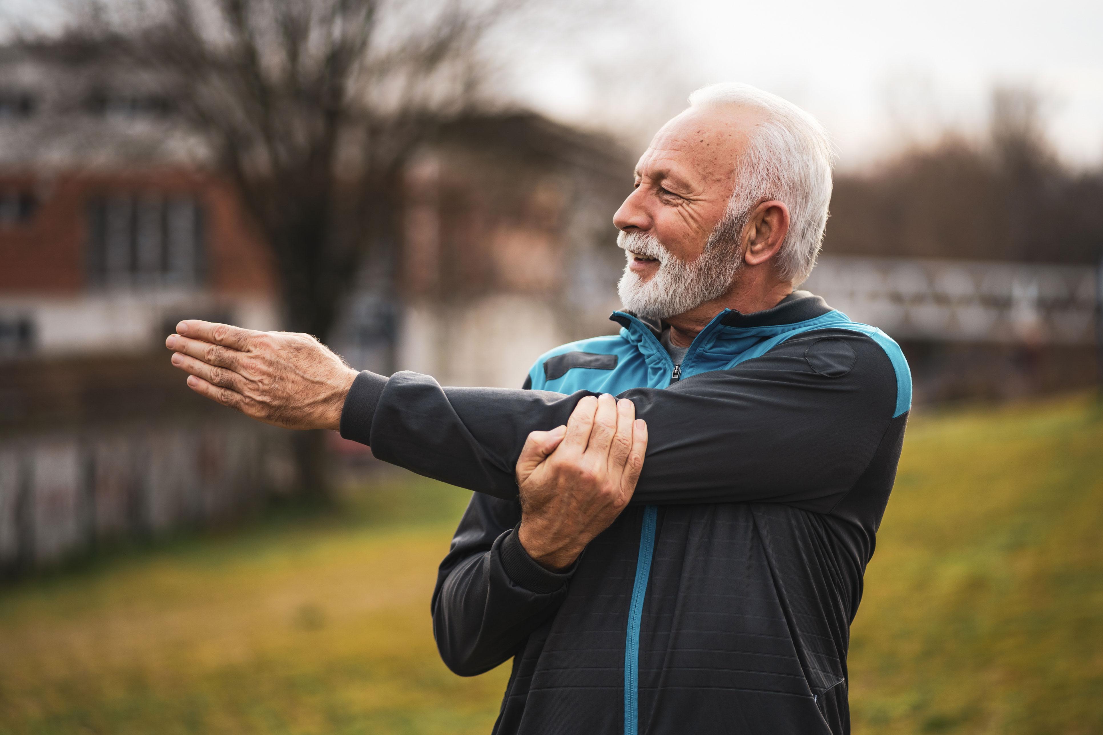 Senior man stretching his arm