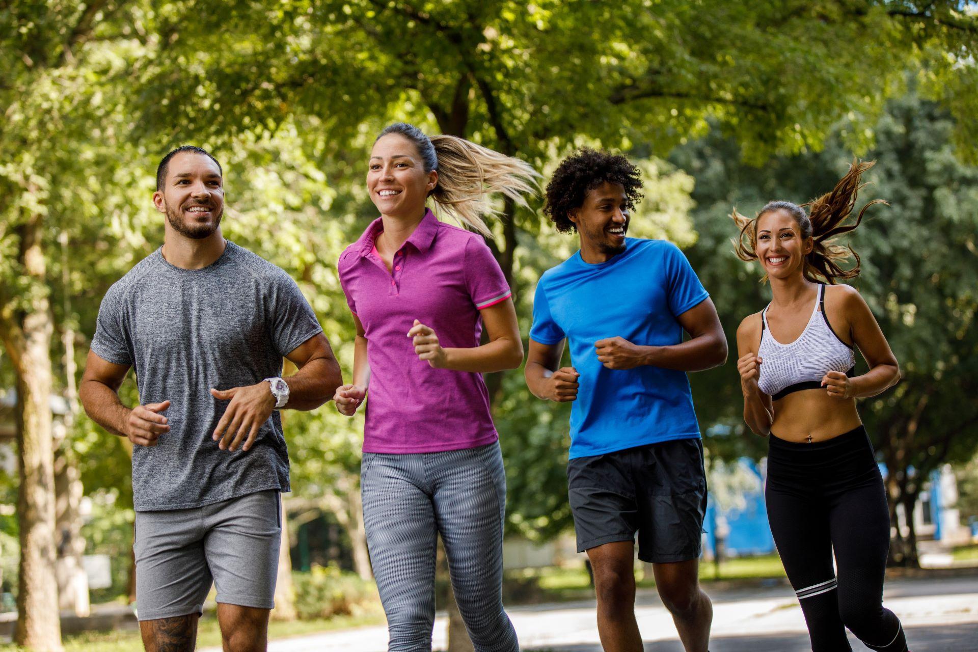 Four friends running outside