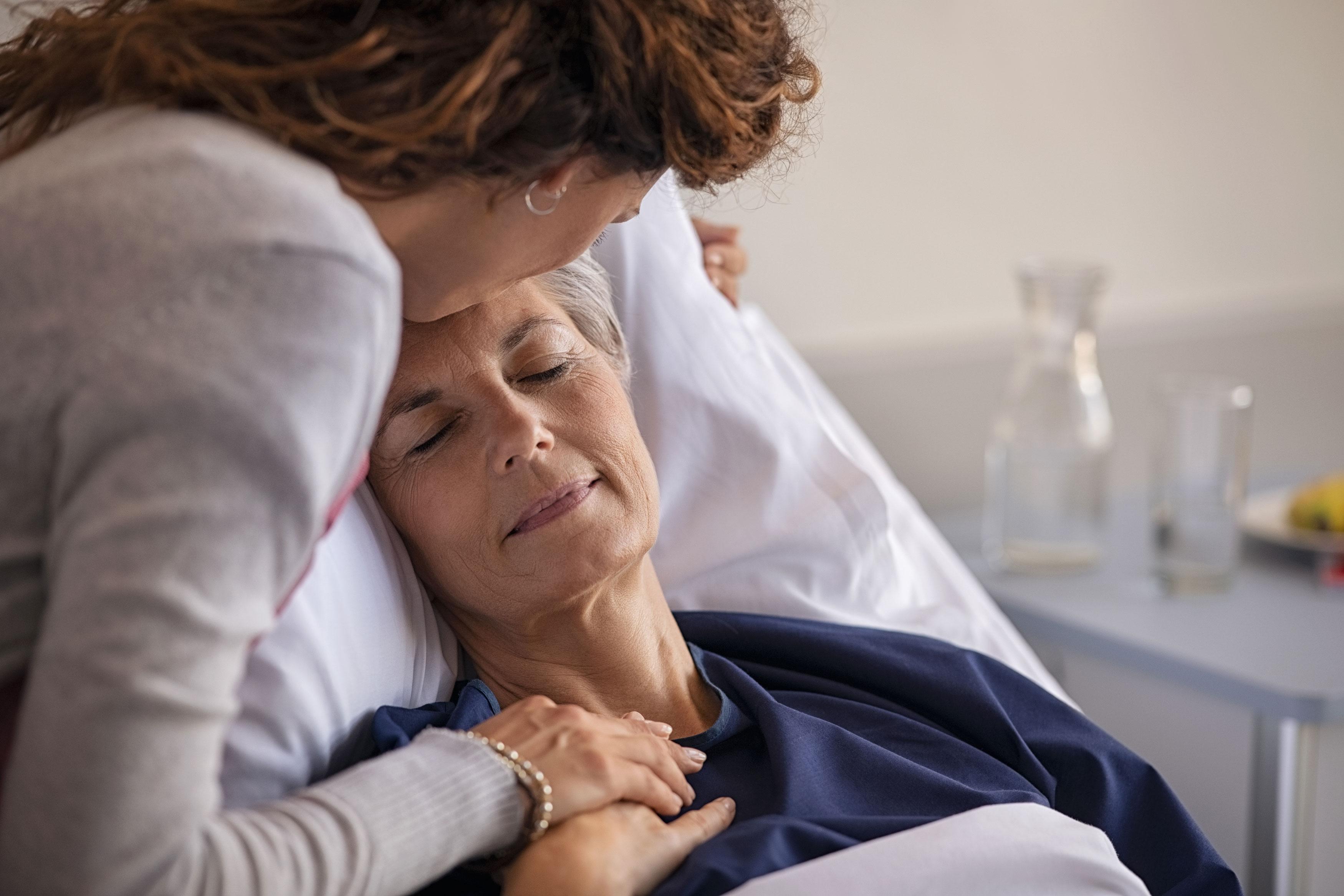 Daughter comforting mother in the hospital