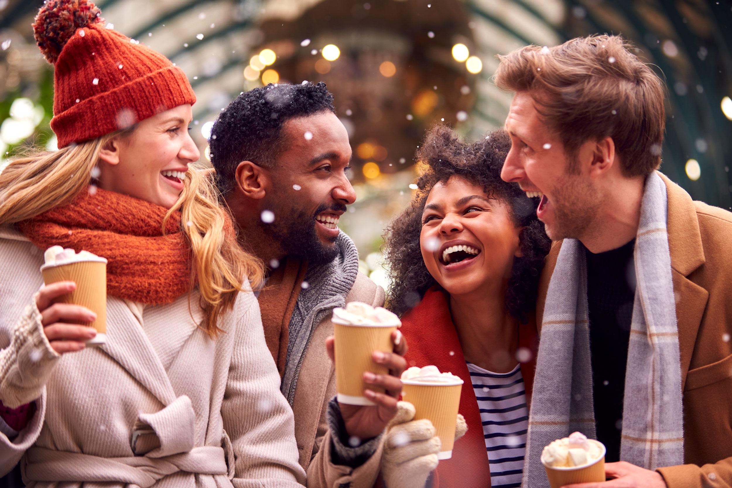 Four friends enjoying hot chocolate in the winter