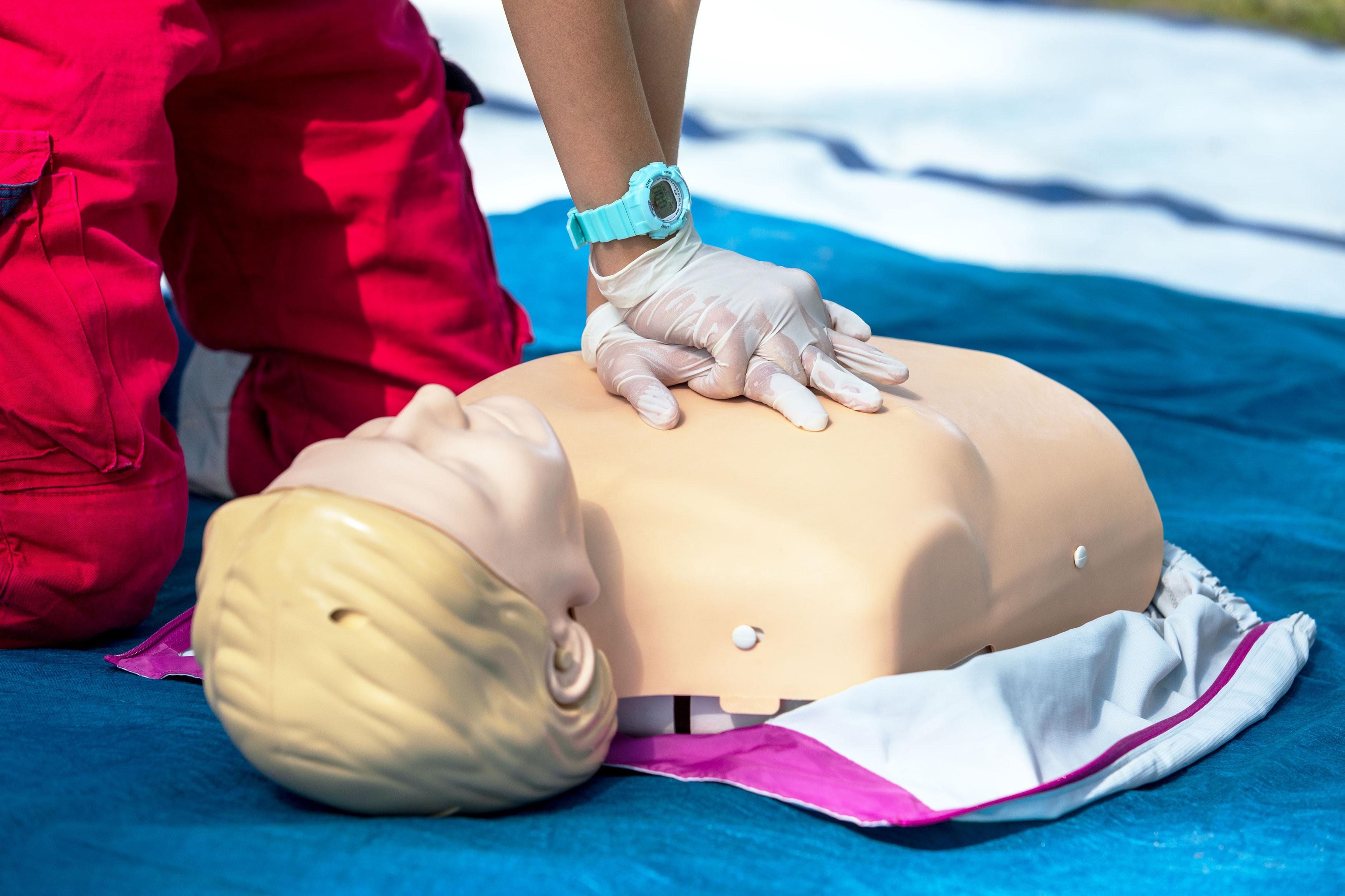 Close up of person's hands doing CPR on a manikin