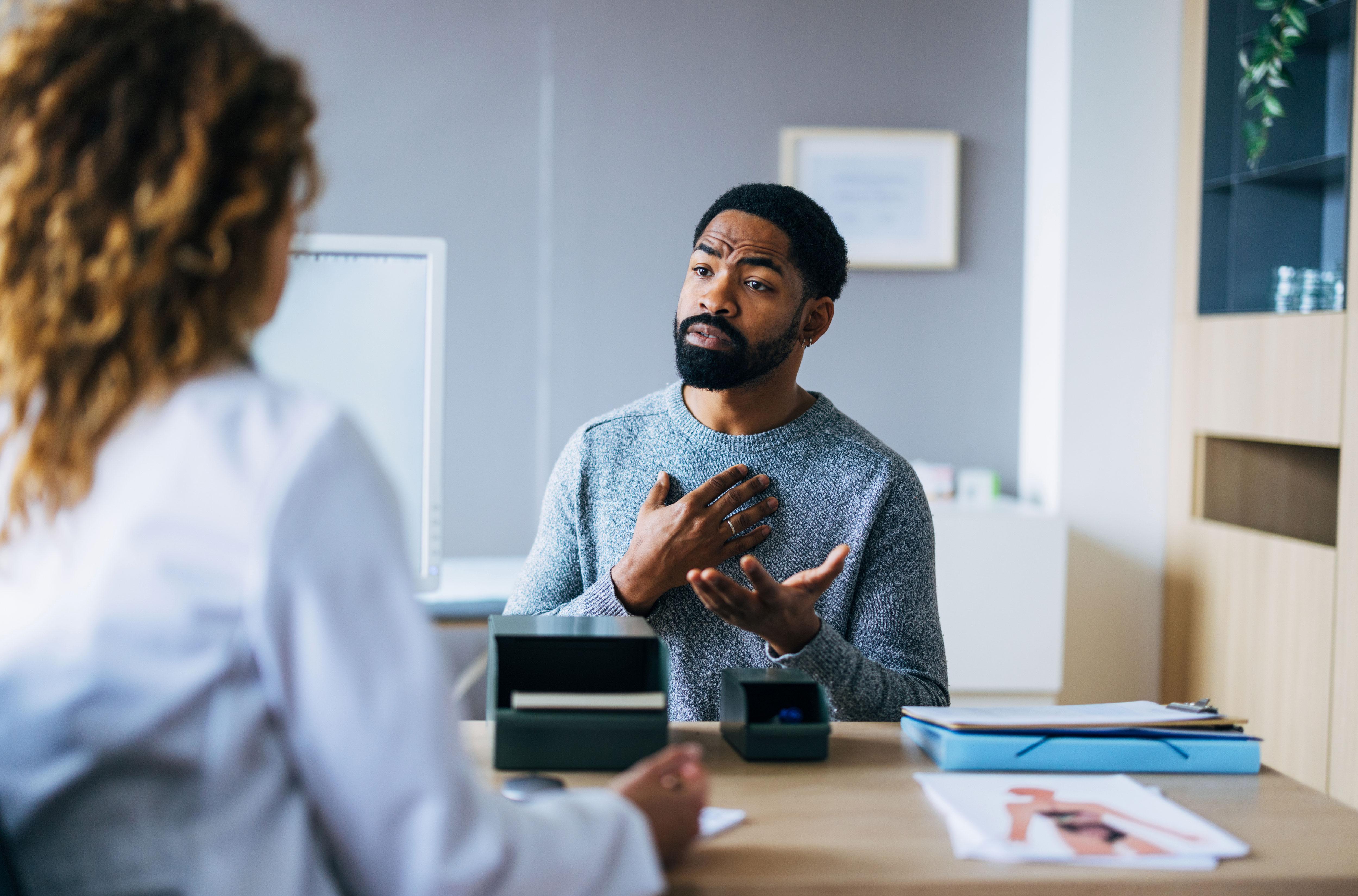 Patient talking to practitioner in white coat