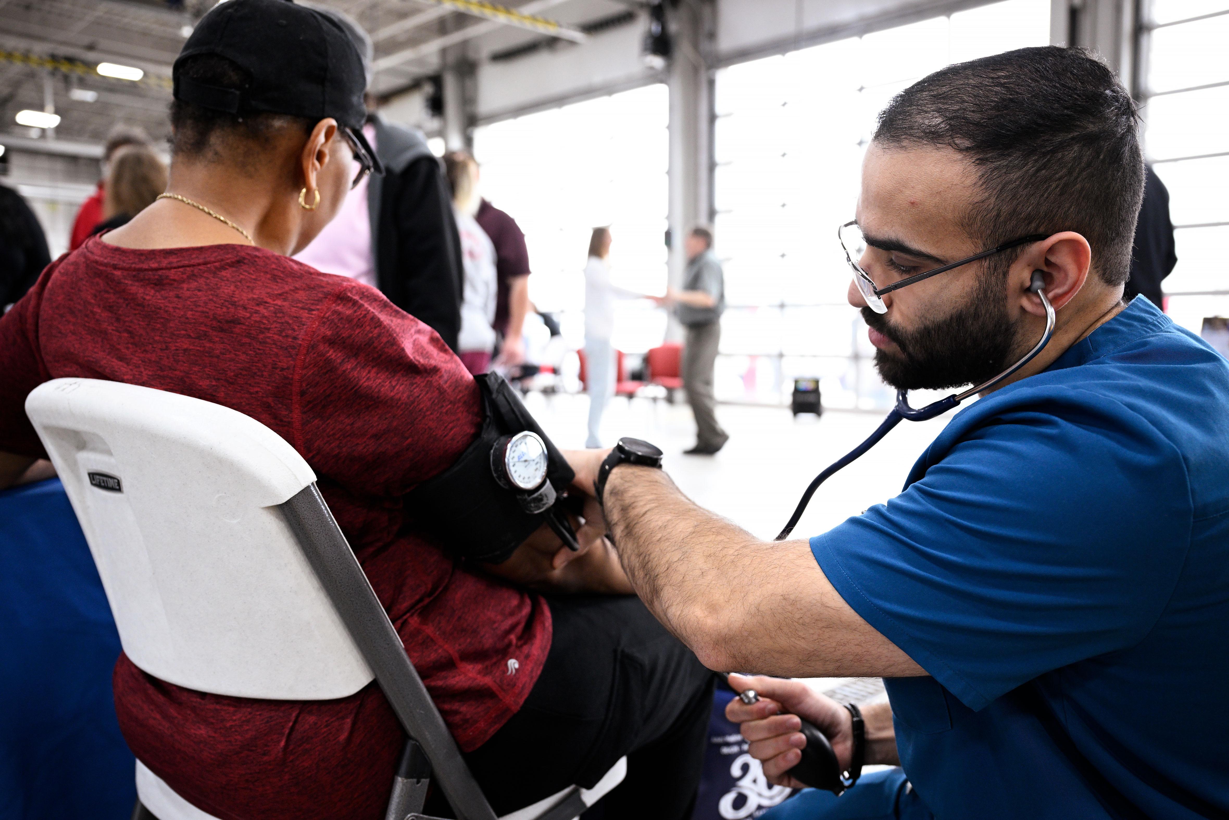 A person gets a screening at HealthFest.