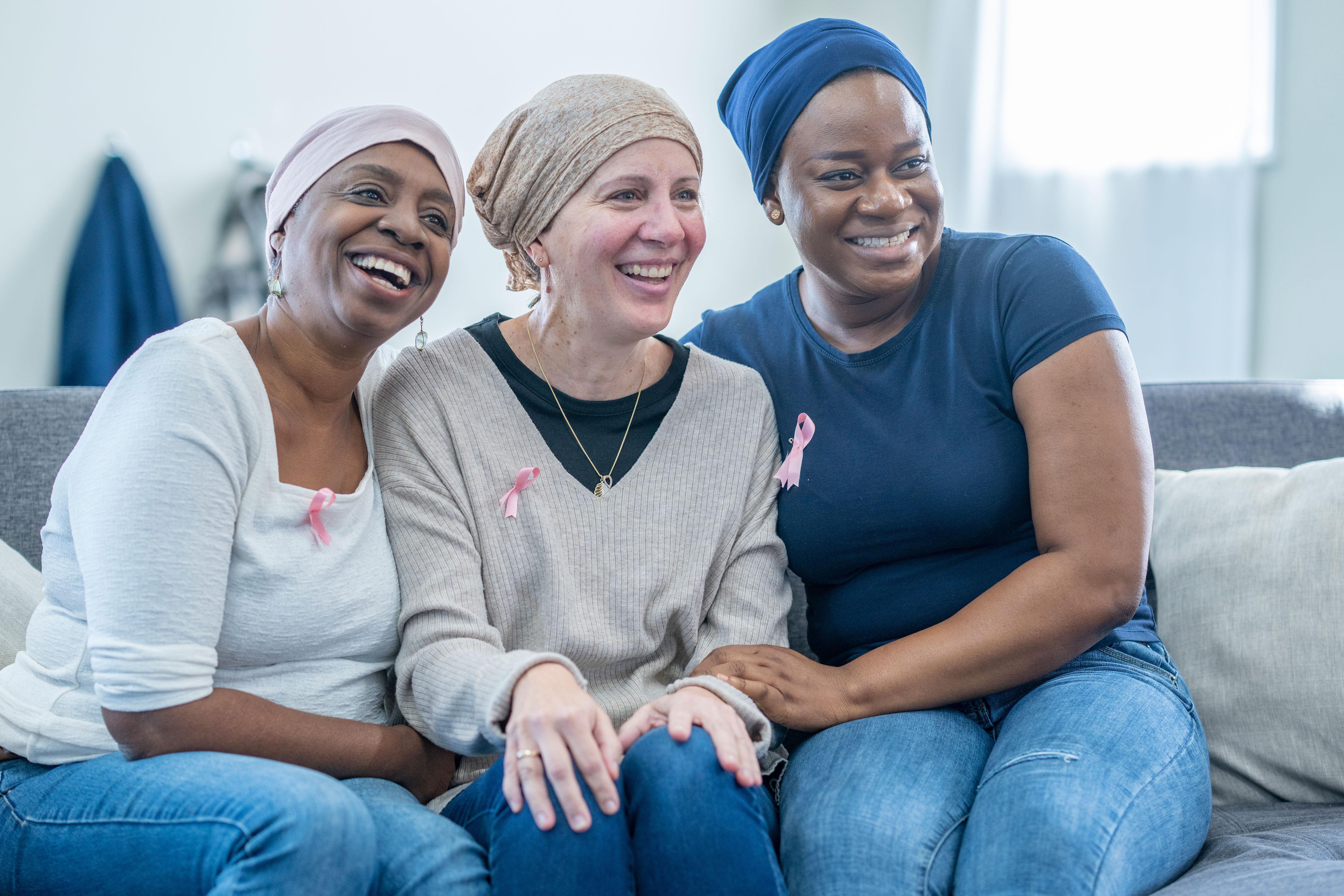 Three breast cancer survivors sit together