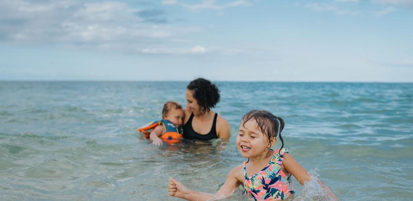 Family swimming at the beach